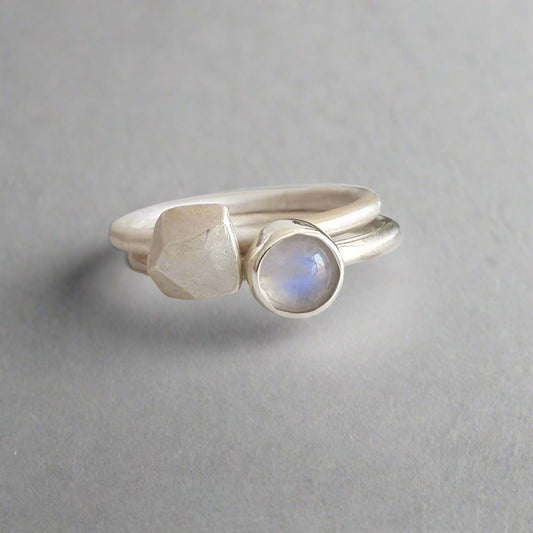 Two silver rings on a textured white surface