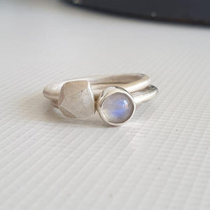 Two silver rings on a textured white surface