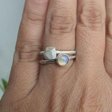 Carica l&#39;immagine nel visualizzatore di Gallery, Two silver rings with gemstones on a person&#39;s finger against a neutral background